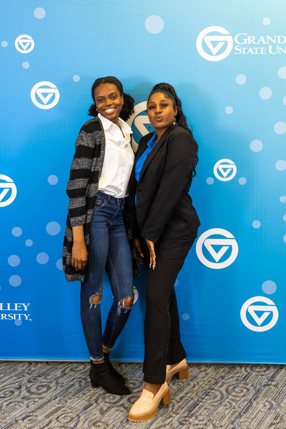 CWGE program staff taking photos at the booth